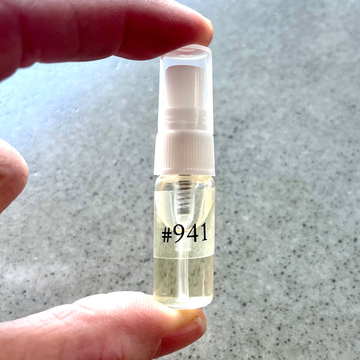 Holding a bottle of dupe samples.