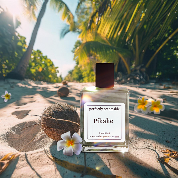 Perfectly Scentsable Pikake perfume oil bottle on a tropical beach with plumeria flowers, coconut, and palm trees.