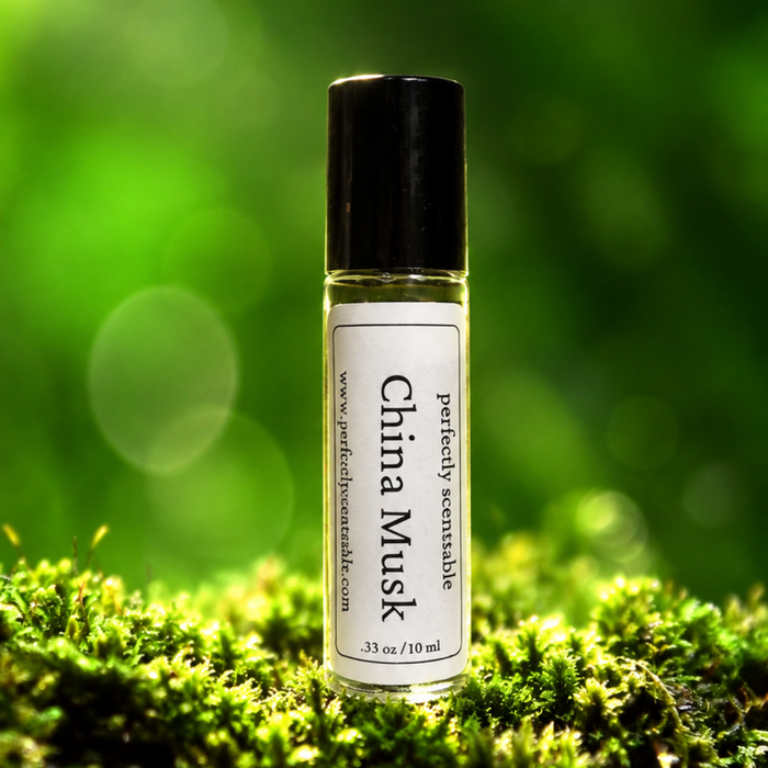 China Musk roll-on perfume bottle standing on bright green moss, with a softly blurred green background and circular bokeh highlights creating a fresh, natural atmosphere.