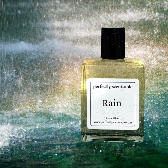 Perfectly Scentsable Rain perfume oil bottle against a misty, water-washed backdrop.