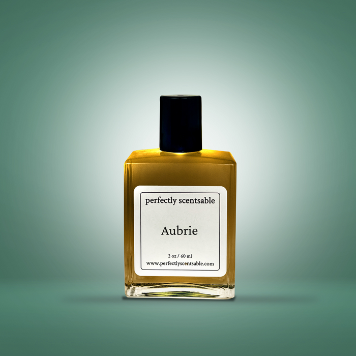 Perfectly Scentsable “Aubrie” perfume oil, 2 oz/60 ml square glass bottle with black cap on a soft green gradient background.