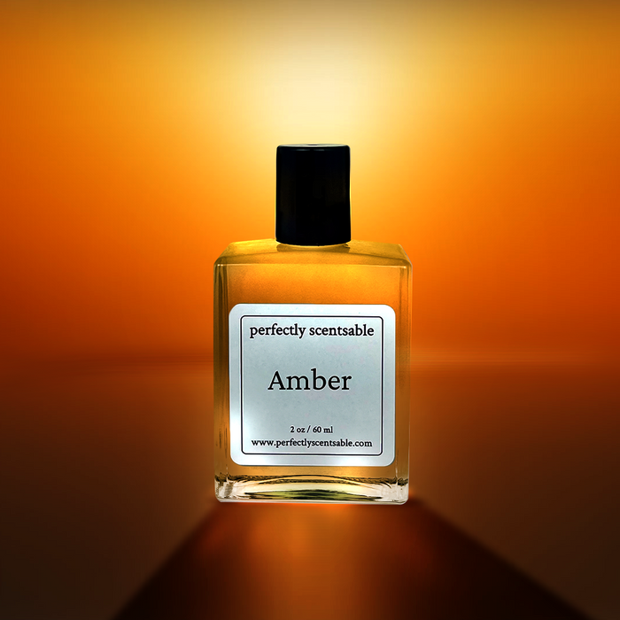 Amber perfume oil by Perfectly Scentsable—square glass bottle glowing against a golden-orange backdrop.