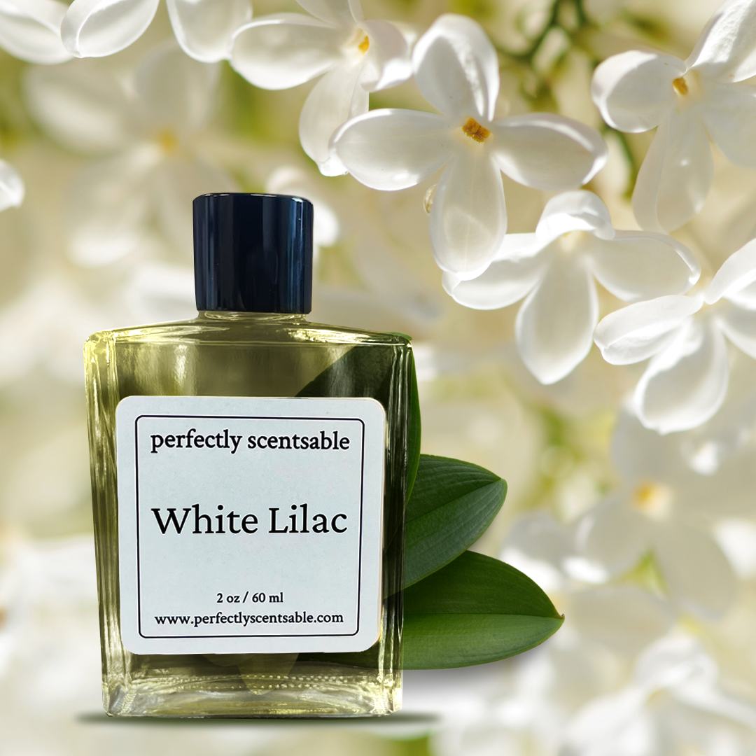 Perfectly Scentsable White Lilac perfume oil bottle with dark cap, framed by white lilac blossoms and green leaves.