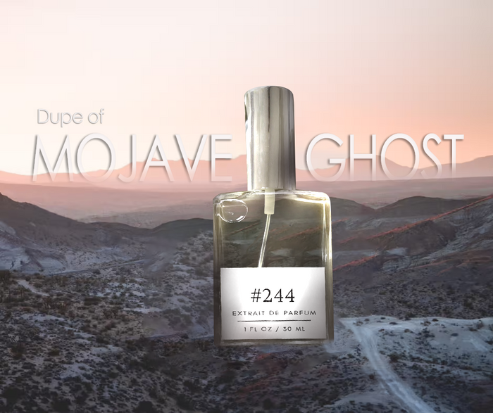 Formula #244 extrait de parfum — dupe of Mojave Ghost — silver-capped bottle over a desert landscape at pink sunset