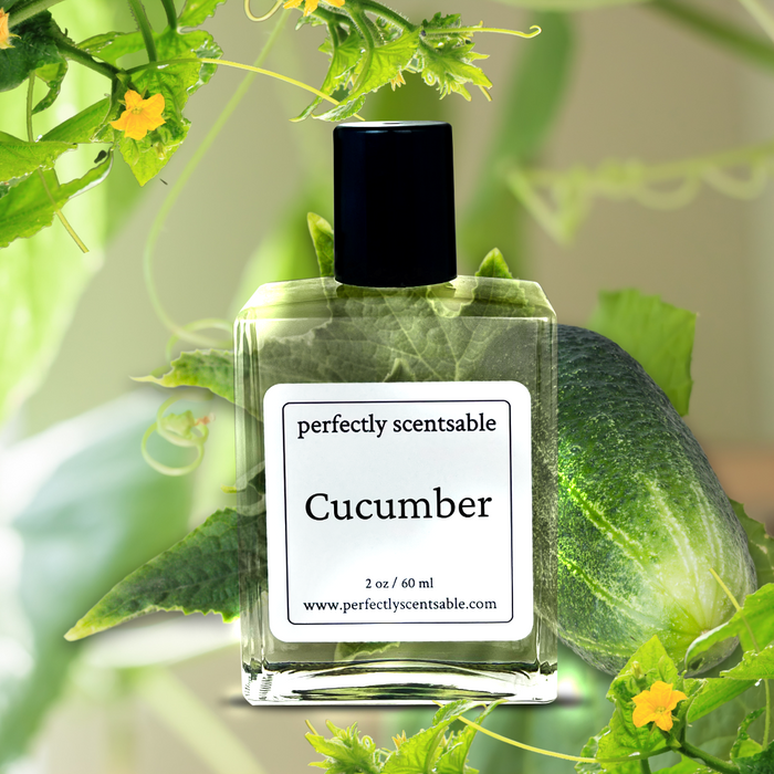 Perfectly Scentsable Cucumber perfume oil bottle set among fresh cucumber vines and leaves, greenhouse-style backdrop.