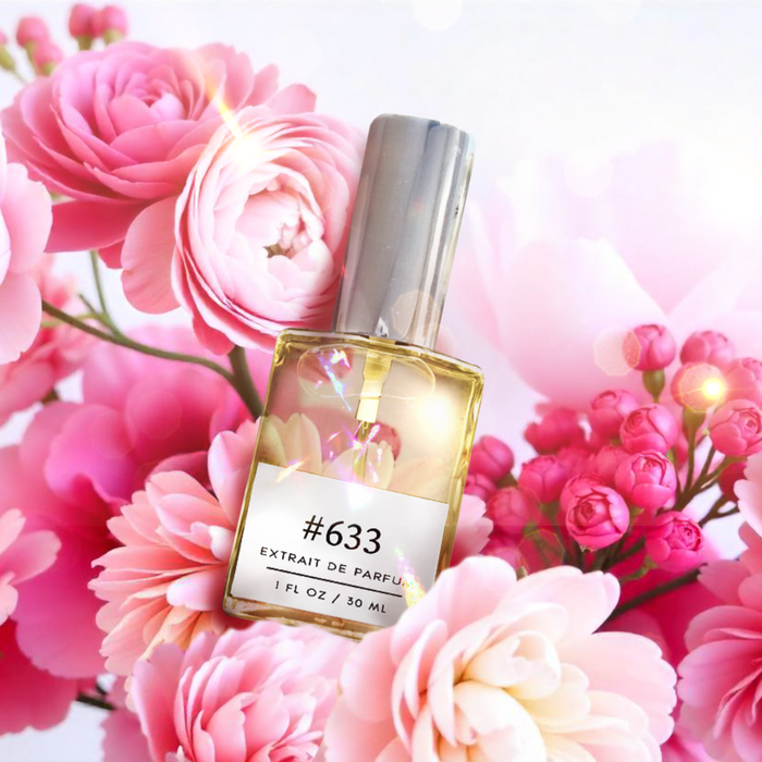 Perfectly Scentsable #633 extrait de parfum — clear 1 fl oz bottle with silver cap surrounded by pink ranunculus and rose blooms on a soft pastel background