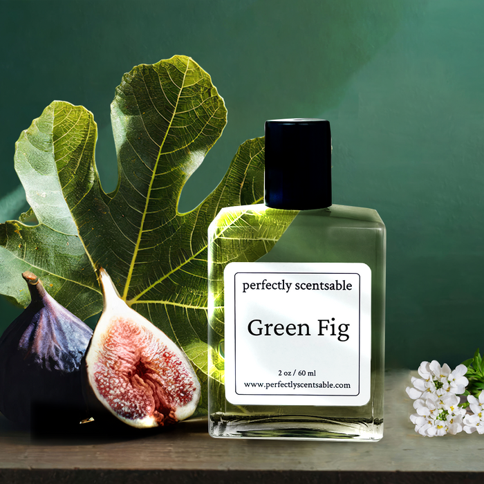Perfectly Scentsable Green Fig perfume oil, 2 oz/60 ml square bottle with black cap beside fig leaves, ripe figs, and a white blossom on a green backdrop.