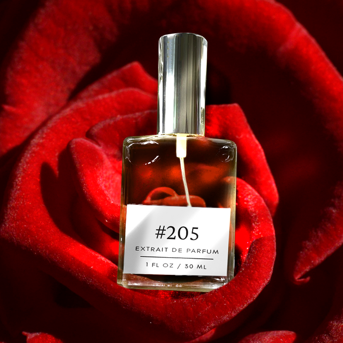 Perfectly Scentsable #205 extrait de parfum — 1 fl oz bottle with silver cap nestled in a close-up of velvety red rose petals