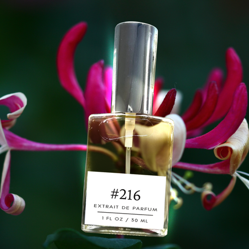 Perfectly Scentsable #216 extrait de parfum — 1 fl oz bottle with silver cap nestled among pink honeysuckle blossoms