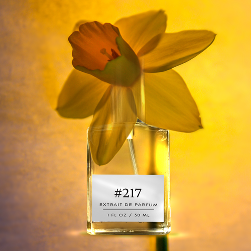 Perfectly Scentsable #217 extrait de parfum — 1 fl oz bottle with silver cap set against a bright yellow daffodil (narcissus) on a warm golden background