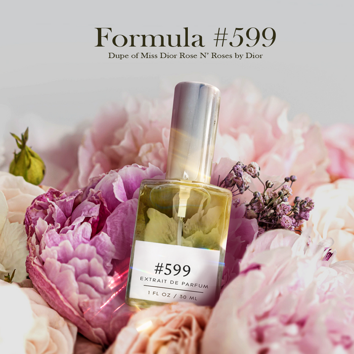 Formula #599 extrait de parfum — dupe of Rose N’ Roses — silver-capped bottle nestled among soft pink peonies and roses