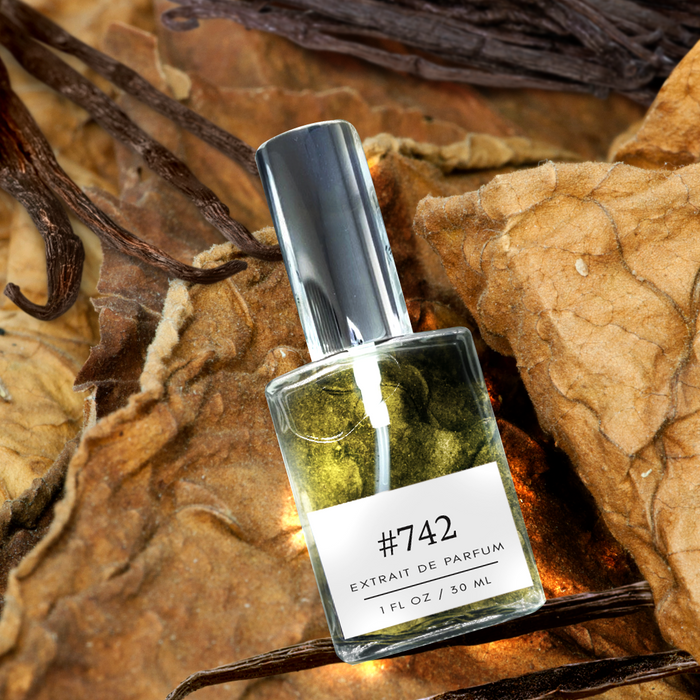 Formula #742 Extrait de Parfum bottle resting on dried tobacco leaves with vanilla pods, close-up, 1 fl oz / 30 ml.