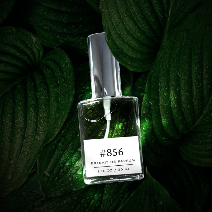 Perfectly Scentsable #856 Extrait de Parfum bottle on dark, dewy green leaves, spotlighted against a lush foliage backdrop.