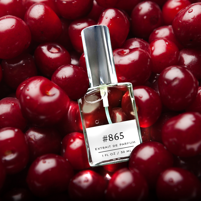 Perfectly Scentsable #865 Extrait de Parfum bottle with silver cap resting on a pile of glossy dark-red cherries, 1 fl oz / 30 ml label visible.