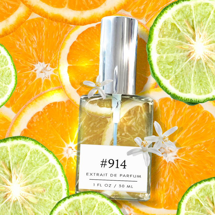 Formula #914 extrait de parfum bottle on a vibrant citrus backdrop of orange and bergamot slices with white orange blossoms.