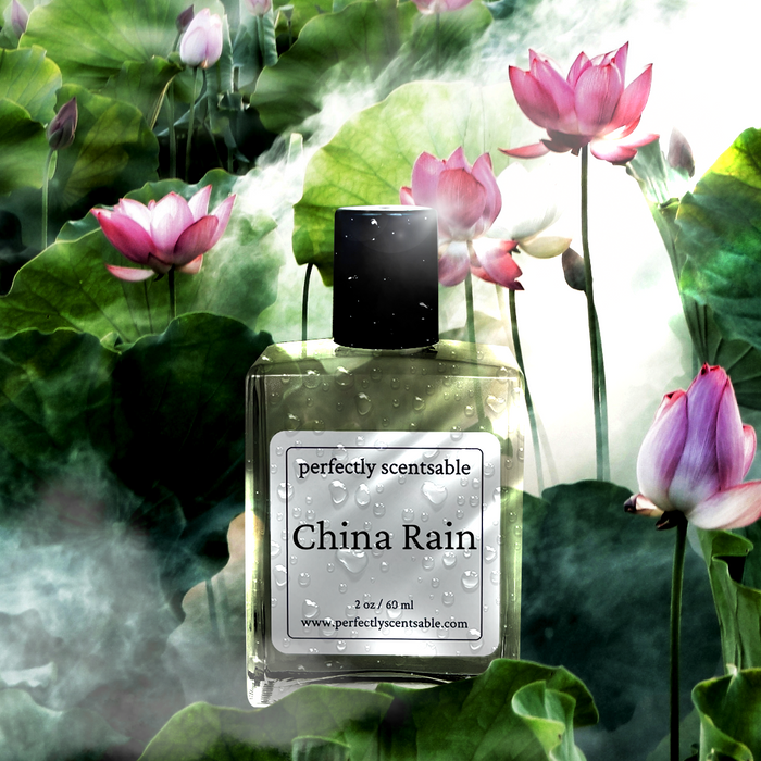 China Rain perfume oil, 2 oz/60 ml, dewy bottle among blooming pink lotuses with drifting mist.