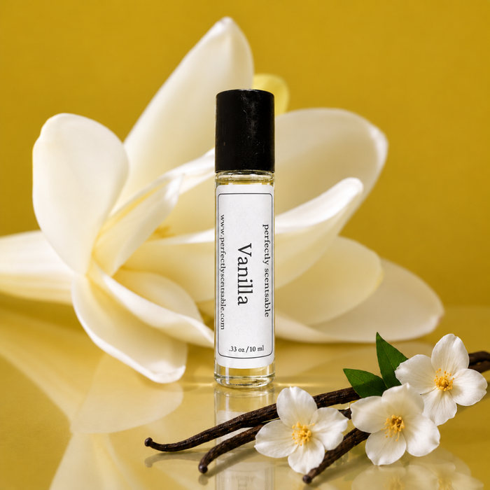 Vanilla roll-on perfume bottle displayed against a warm golden background, surrounded by creamy white vanilla flowers and dark vanilla pods with soft reflections on the surface.