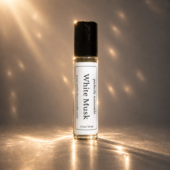 White Musk roll-on perfume bottle standing upright against a warm neutral background, illuminated by soft golden light with sparkling highlights and subtle reflections on the surface.