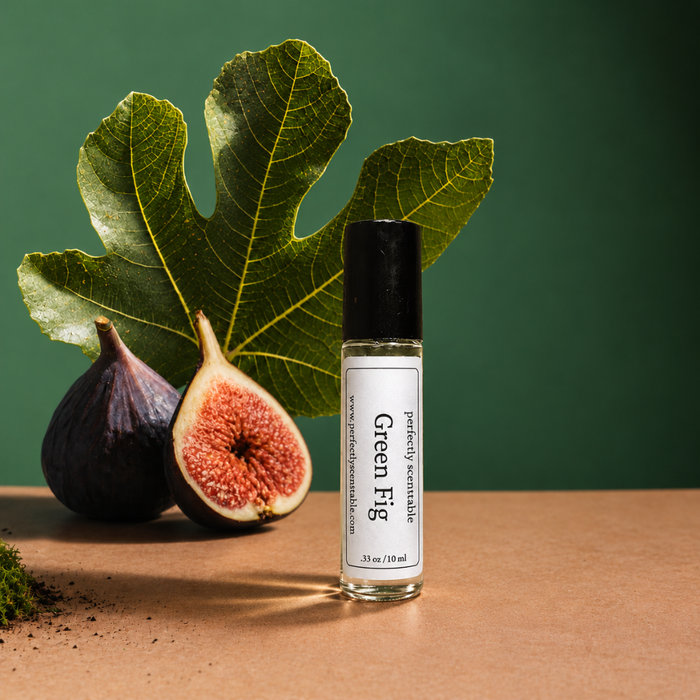 Perfectly Scentsable Green Fig perfume oil, 2 oz/60 ml square bottle with black cap beside fig leaves, ripe figs, and a white blossom on a green backdrop.