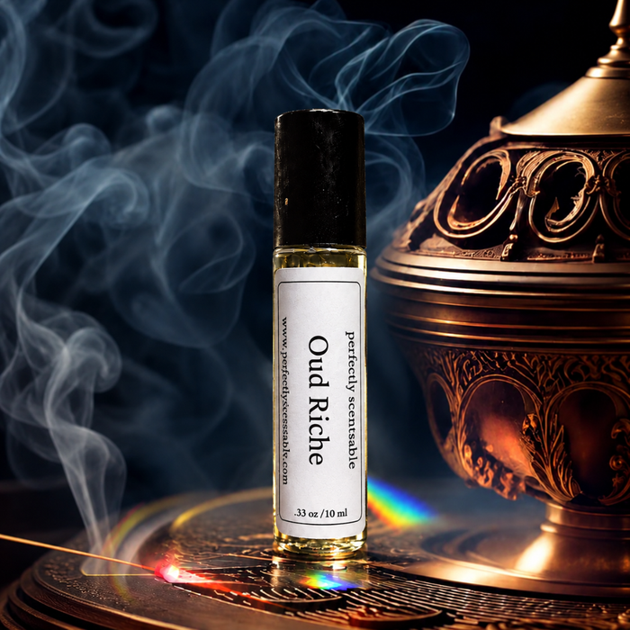 Oud Riche roll-on perfume bottle displayed beside an ornate bronze incense burner, surrounded by swirling smoke and warm reflections against a dark, luxurious background.