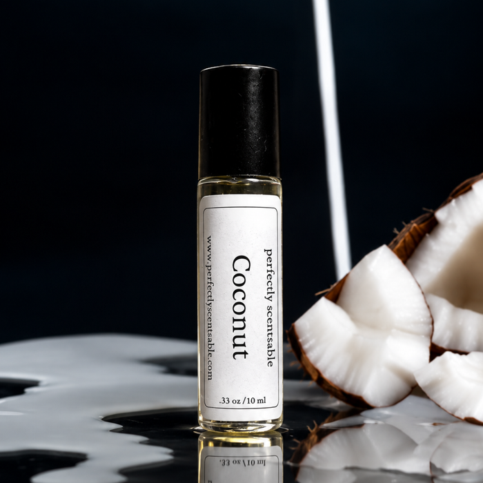 Coconut roll-on perfume bottle displayed beside freshly cut coconut pieces, with creamy coconut milk splashes on a glossy black surface against a dark background.