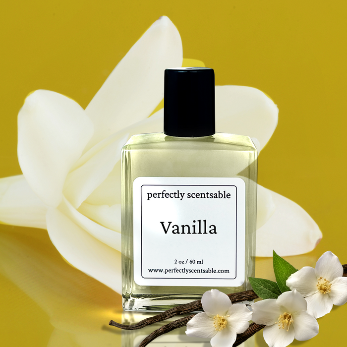 Perfectly Scentsable Vanilla perfume oil bottle with vanilla beans and white blossoms against a warm golden backdrop and large white flower.