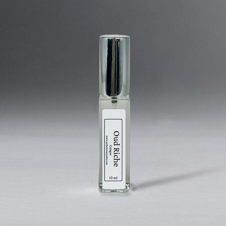 Clear 10 ml oil bottle in a rectangular shape with a silver cap, elegantly standing against a gray background.
