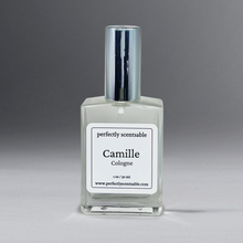 Load image into Gallery viewer, Clear 1 oz cologne bottle with silver cap, gracefully standing against a neutral gray background.
