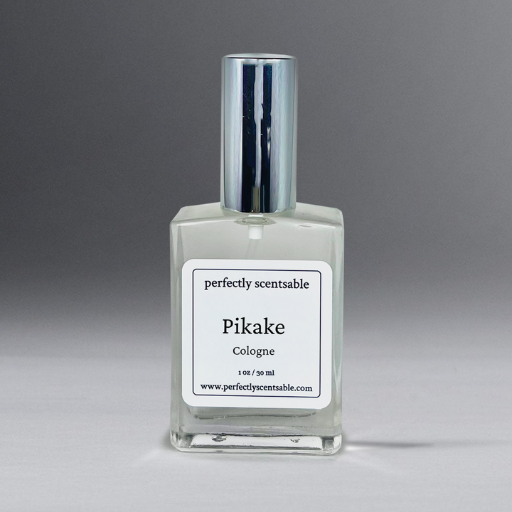 Clear 1 oz cologne bottle with silver cap, gracefully standing against a neutral gray background.