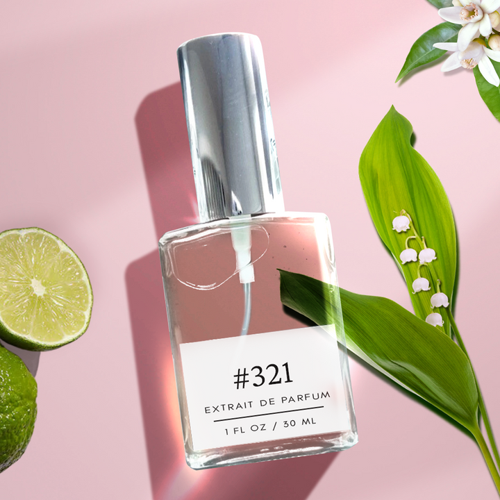 A silver-capped bottle labeled '321 Amazing Grace Dupe Fragrance - Bergamot, Lily, Musk' stands against an elegant pink background adorned with neroli flowers, lilies, and lime fruits. The fragrance bottle holds 1 fl/30 ml of the exquisite scent, capturing the essence of luxury and sophistication.