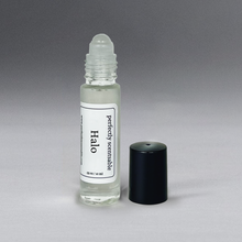Load image into Gallery viewer, Clear 0.33 oz roller bottle without lid, set against a gray background, standing upright.
