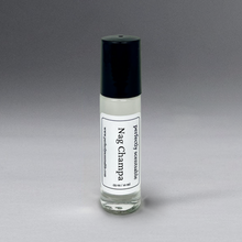 Load image into Gallery viewer, Clear 0.33 oz roller bottle with lid, elegantly standing against a gray background.
