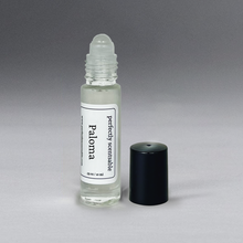 Load image into Gallery viewer, Clear 0.33 oz roller bottle without lid, set against a gray background, standing upright.
