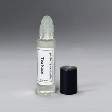 Load image into Gallery viewer, Clear 0.33 oz roller bottle without lid, set against a gray background, standing upright
