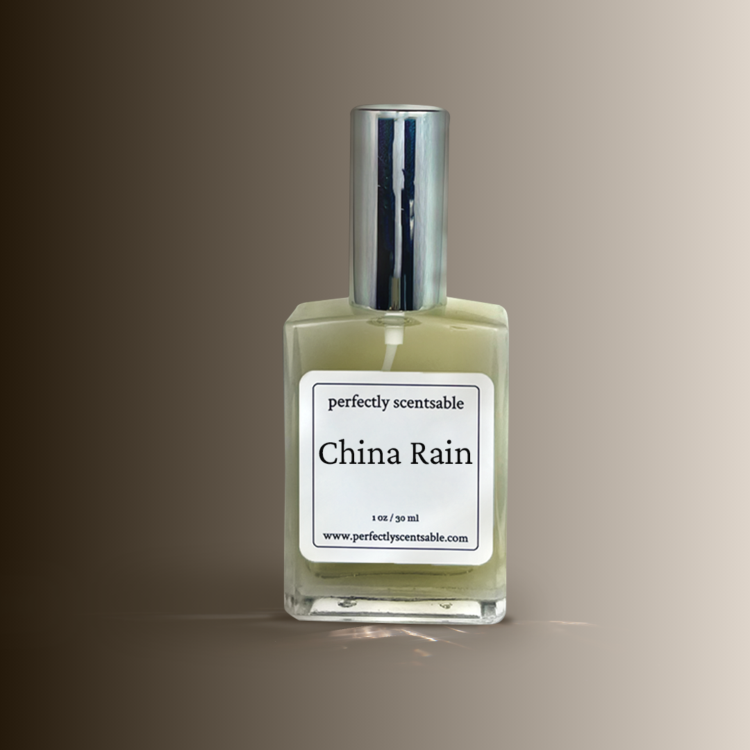 A square glass bottle labeled china rain by Perfectly Scentsable with a silver cap, set 
against a brown to beige gradient background.