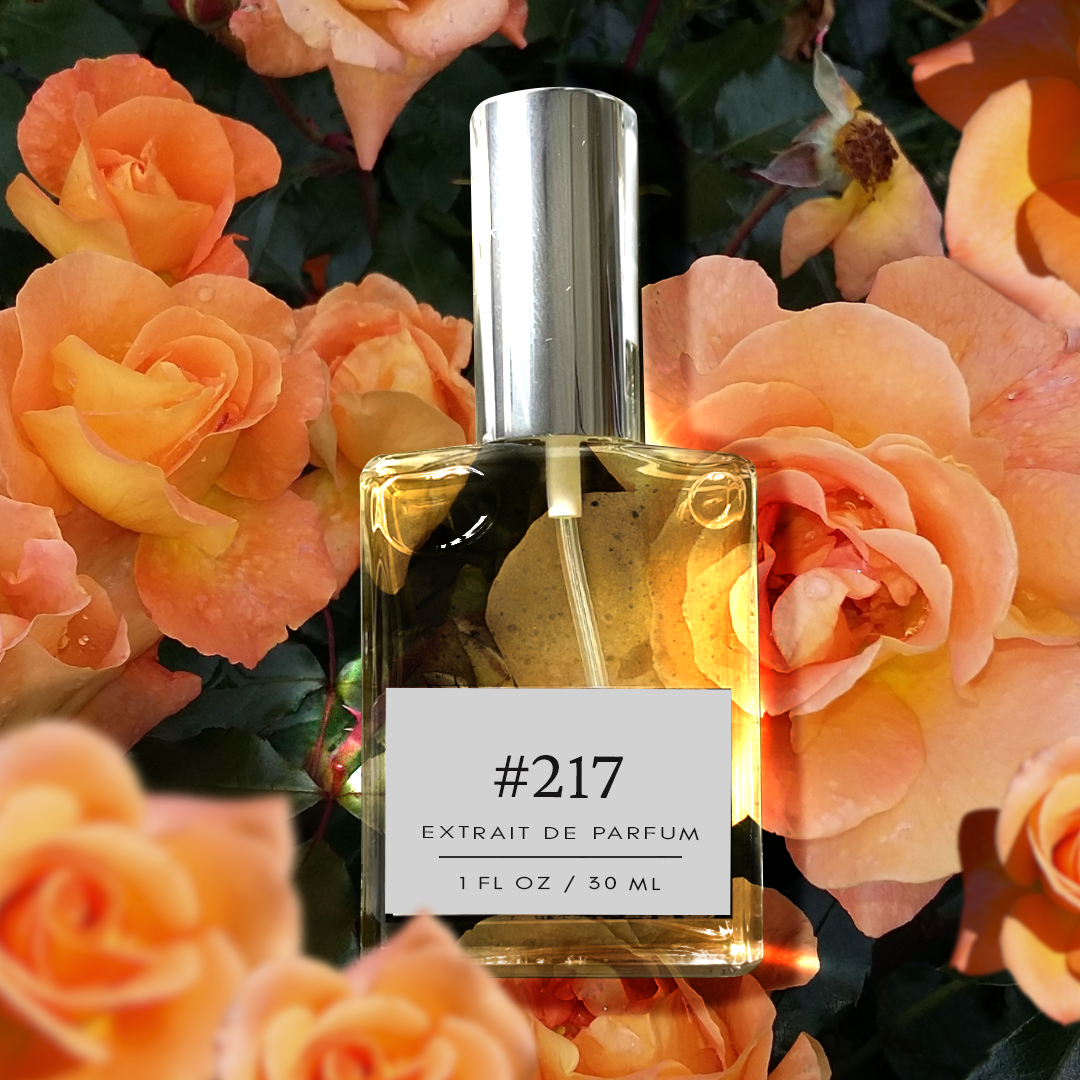 A bottle of Chloe Naarcisse-Inspired Floral Fragrance with a silver cap and a 1 fl/30 ml label stands against a dark background. The elegant perfume bottle is surrounded by a vibrant orange rose with green leaves, highlighting the intense and feminine essence of the fragrance.