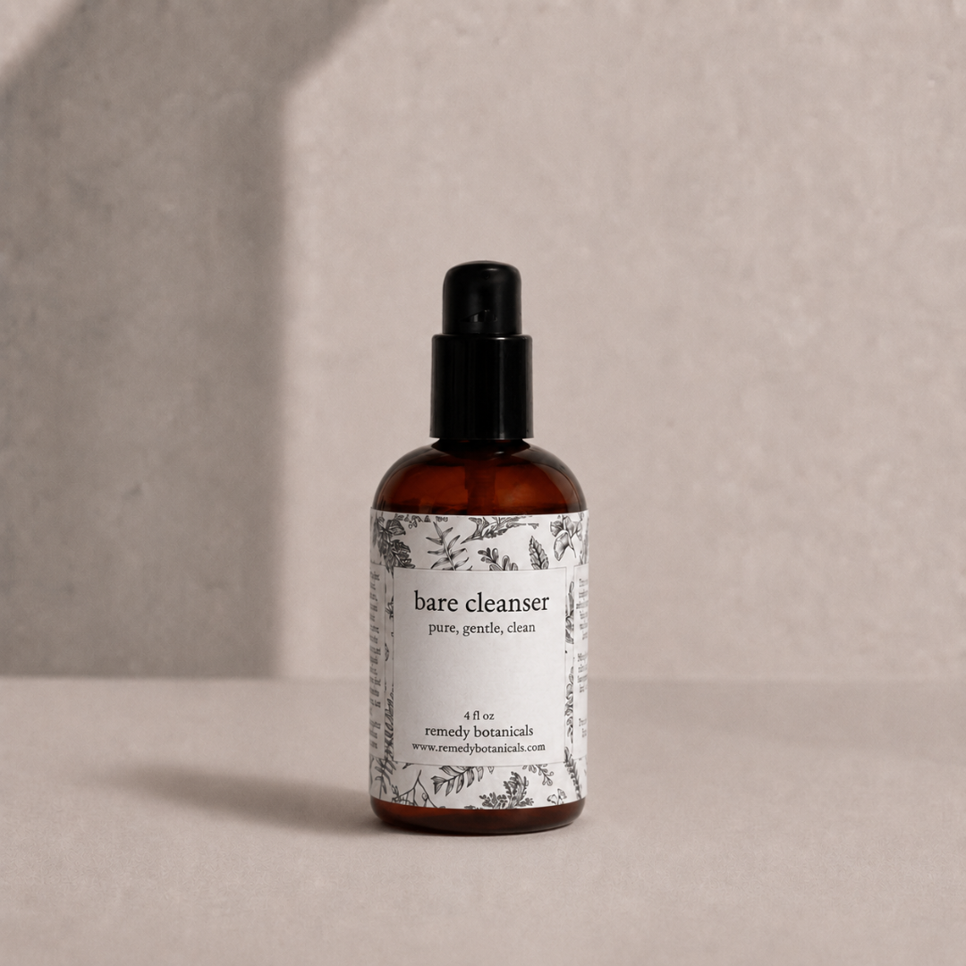 Bare Cleanser in an amber plastic pump bottle on a soft beige background.