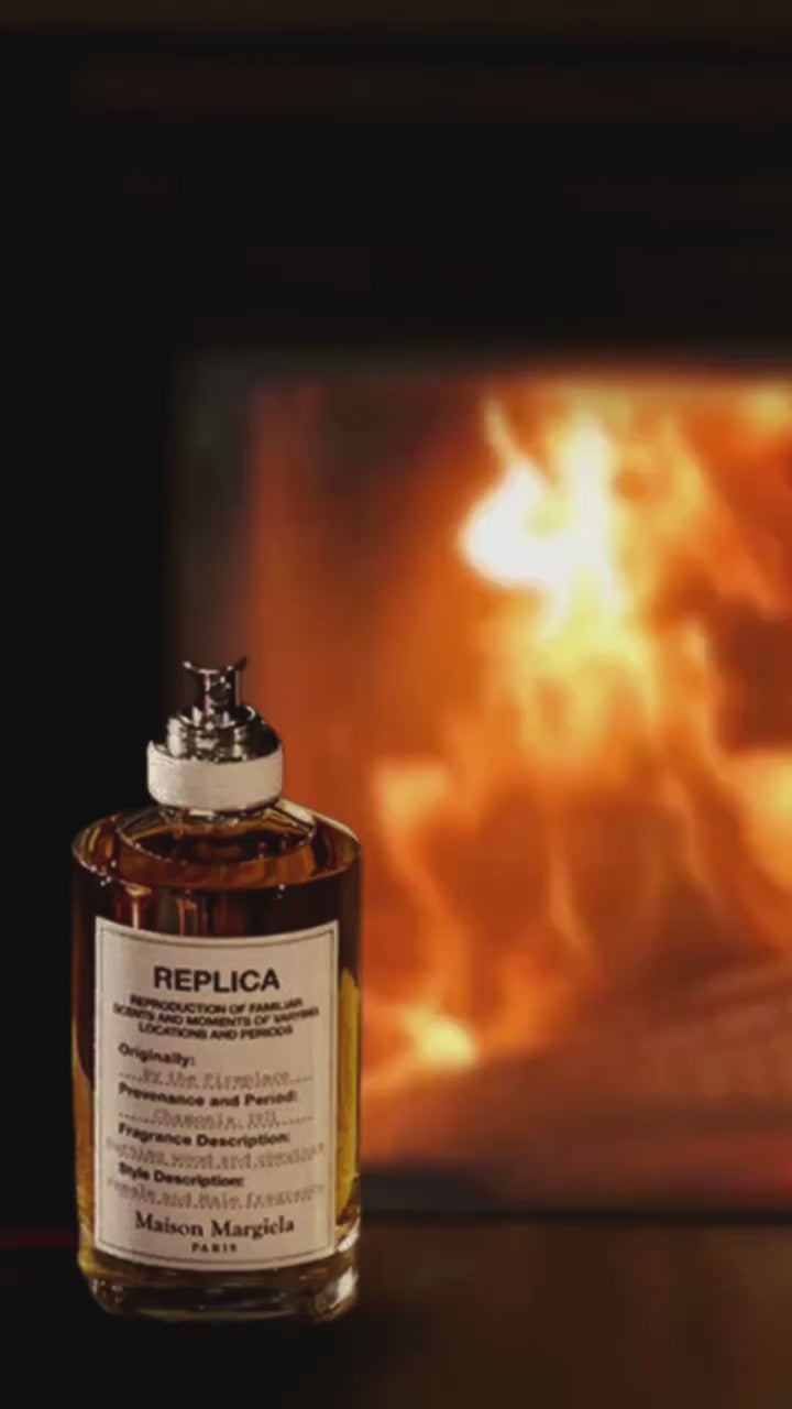 In a cozy setting, a fireplace crackles warmly in the background. A bottle of Margiela's 'By the Fireplace' fragrance stands elegantly beside it. A marshmallow roasts on a bonfire, creating a perfect s'more. The video ends with a captivating shot of both the 'By the Fireplace' fragrance bottle and Replica's formula #277, evoking the essence of warmth and luxury.