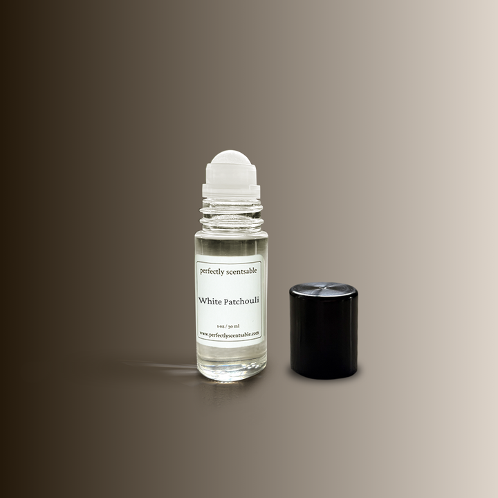 1oz rollerball White Patchouli clear glass rollerball with white ball and black cap beside it